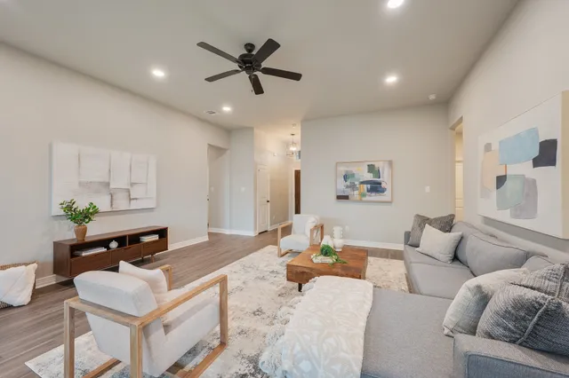 a living room with furniture and a wooden floor
