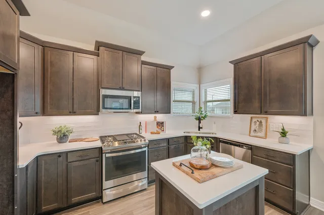 a kitchen with a sink stove and refrigerator