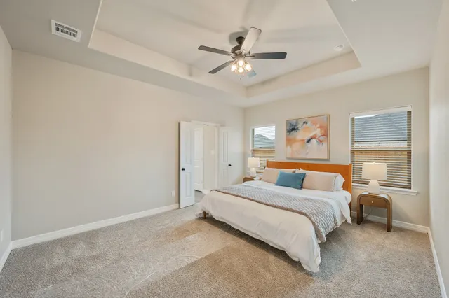 a bedroom with a bed and a chandelier