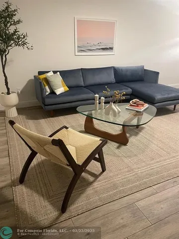 a living room with furniture and potted plant