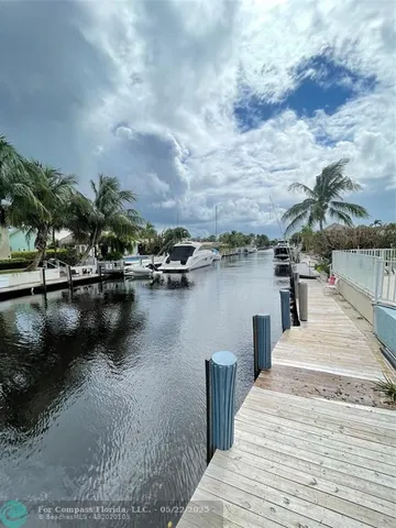 a view of a lake with boats and trees in the background