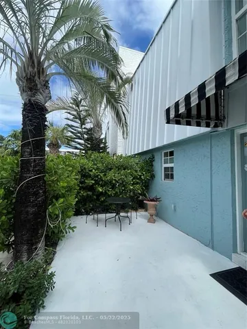 a view of bushes and potted plants