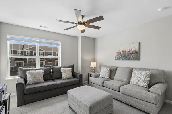 a living room with furniture and a large window