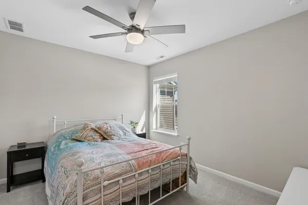 a bedroom with a bed and window