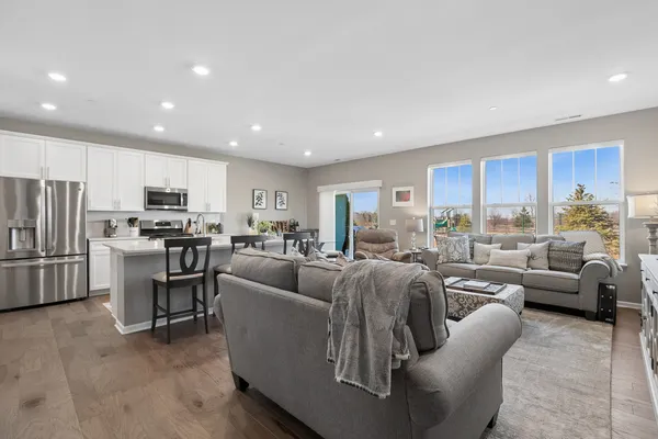 a living room kitchen with furniture and a large window