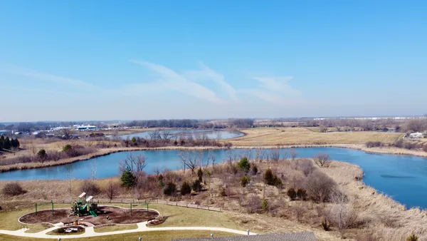 a view of a lake with tall buildings in the background