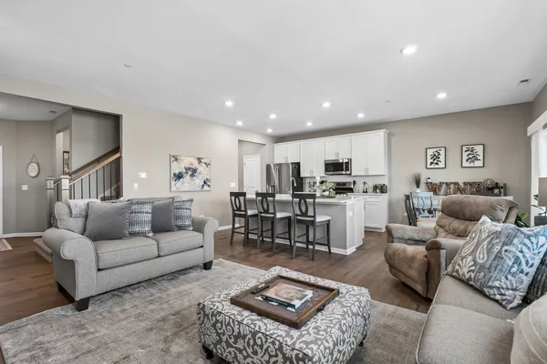 a living room with furniture kitchen view and a table