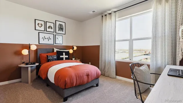 a bed room with a bed and a chair