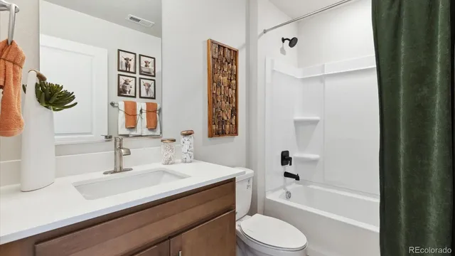 a bathroom with a sink a toilet and bathtub
