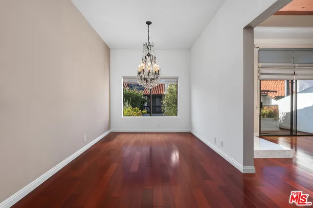 a window in an empty room with wooden floor