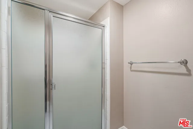 a bathroom with a glass shower door