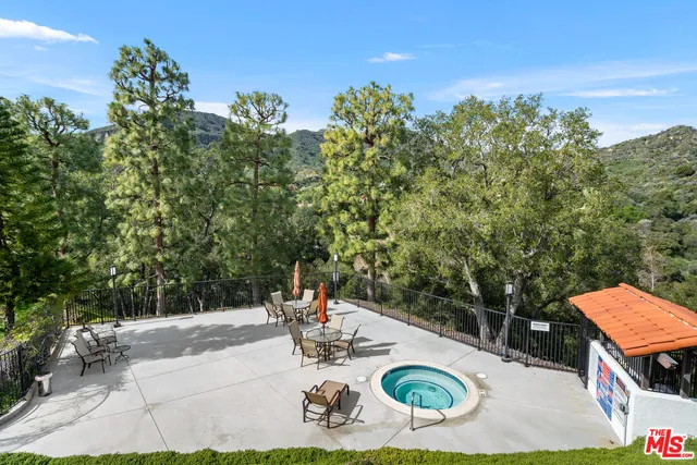 a view of swimming pool with outdoor seating and green space