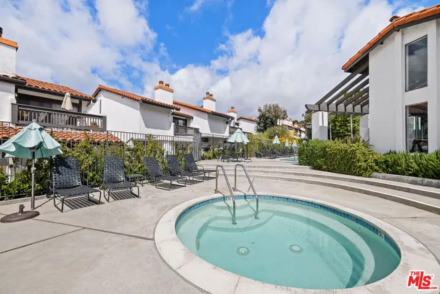 a view of a house with pool and sitting area