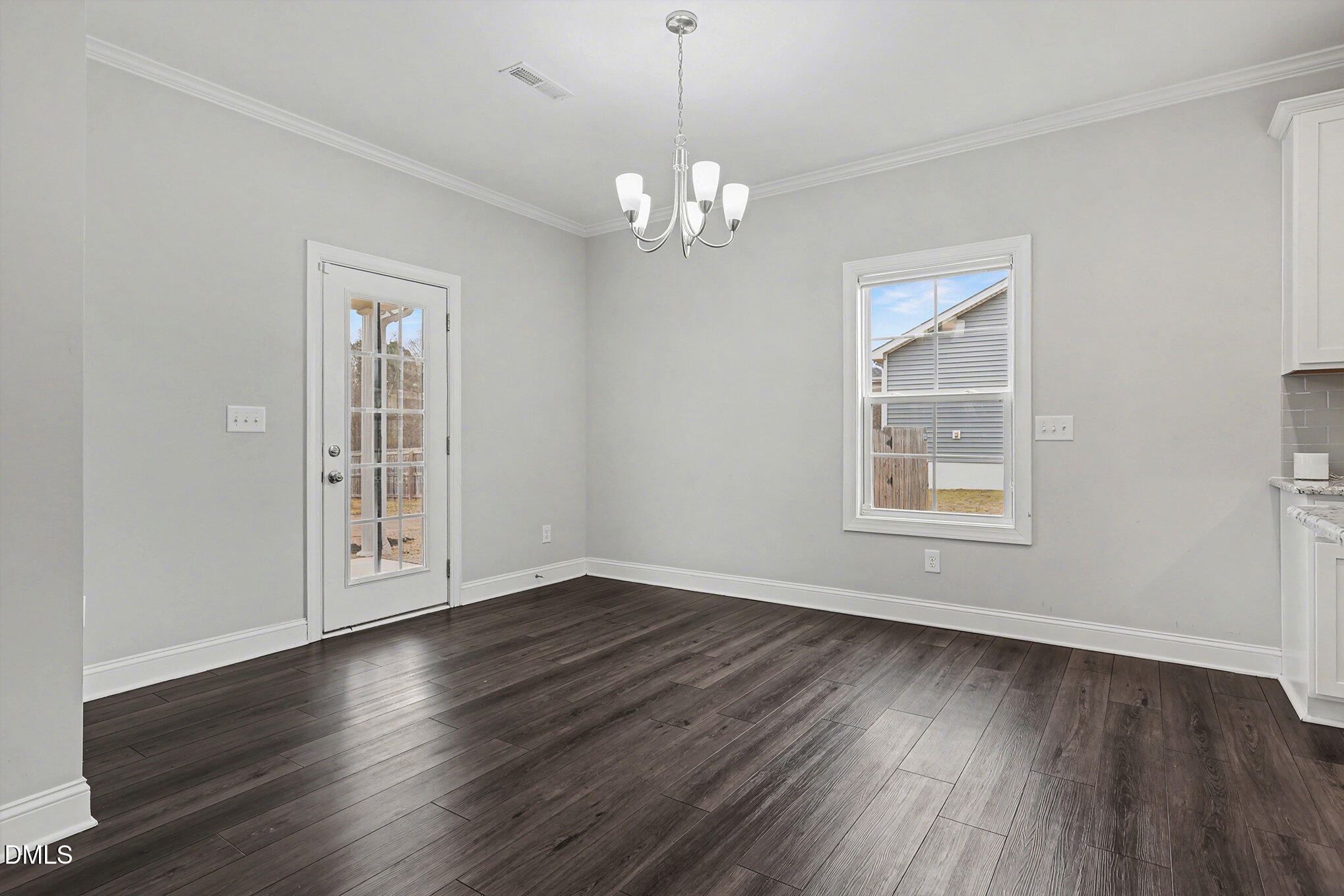 274 Howards Crossing Drive Wendell, NC 27591 - Photo 8 of 40 a view of an empty room with wooden floor and a window