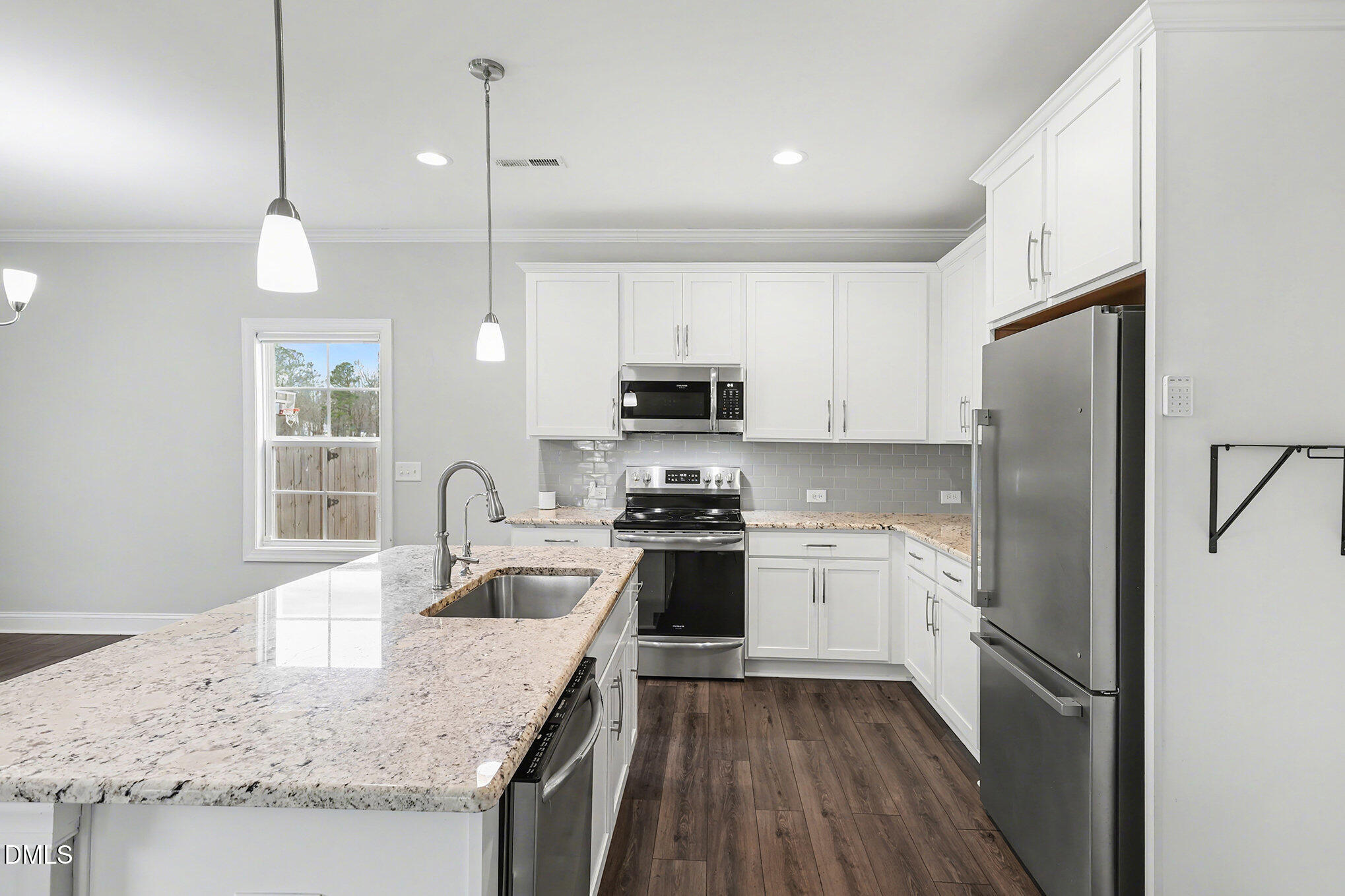274 Howards Crossing Drive Wendell, NC 27591 - Photo 9 of 40 a kitchen with a sink a stove a refrigerator and cabinetry