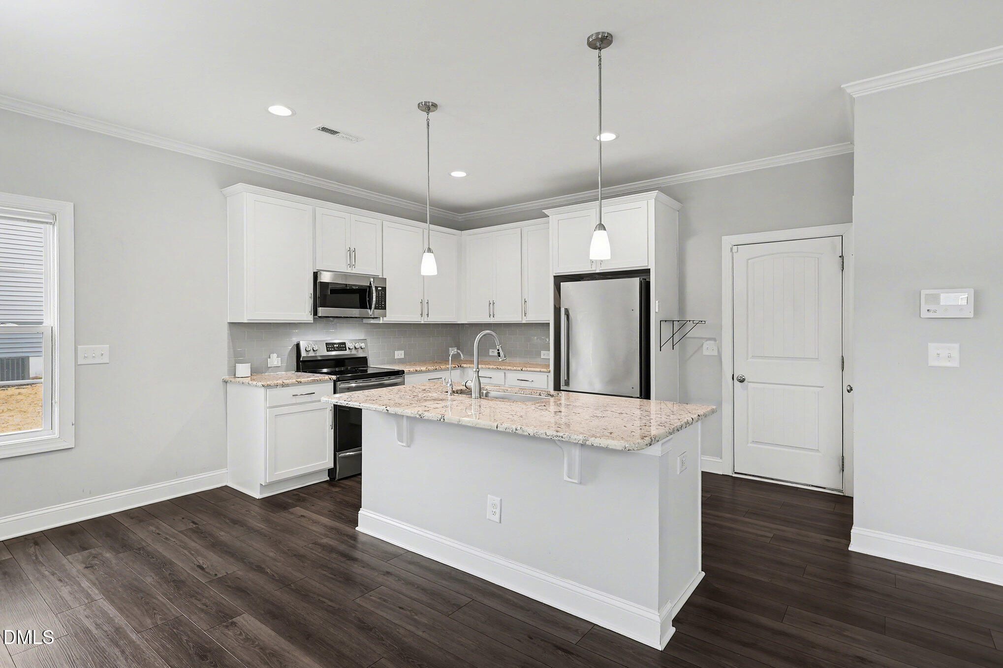 274 Howards Crossing Drive Wendell, NC 27591 - Photo 11 of 40 a kitchen with stainless steel appliances granite countertop a refrigerator a stove top oven a sink and dishwasher with wooden floor