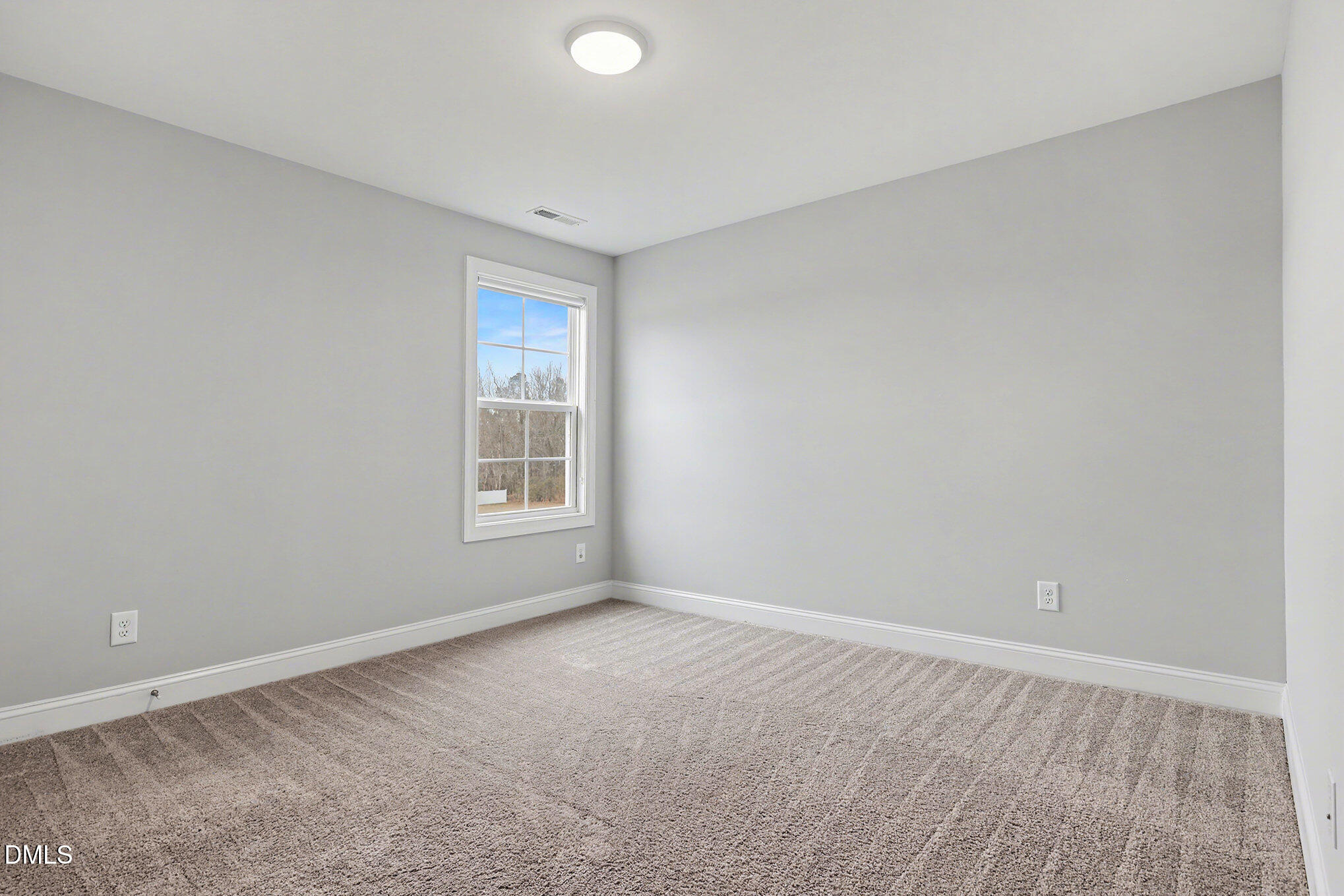 274 Howards Crossing Drive Wendell, NC 27591 - Photo 20 of 40 a view of an empty room with wooden floor and a window