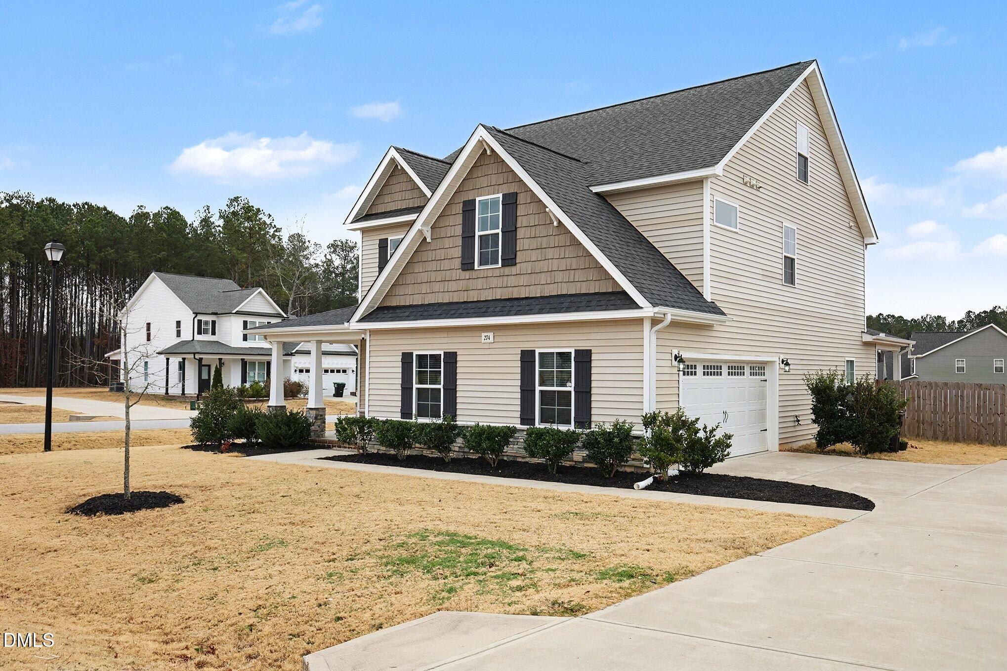 274 Howards Crossing Drive Wendell, NC 27591 - Photo 3 of 40 a front view of a house with a yard and garage
