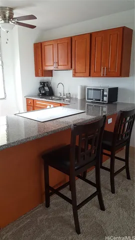 a kitchen with a sink cabinets and window
