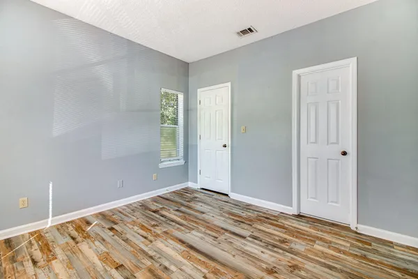 a view of a room with wooden floor