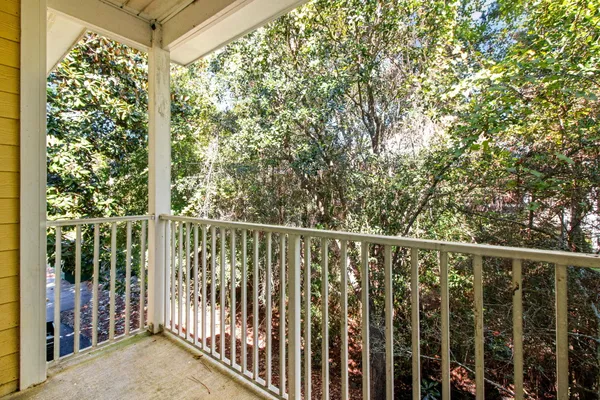 a view of a balcony with trees