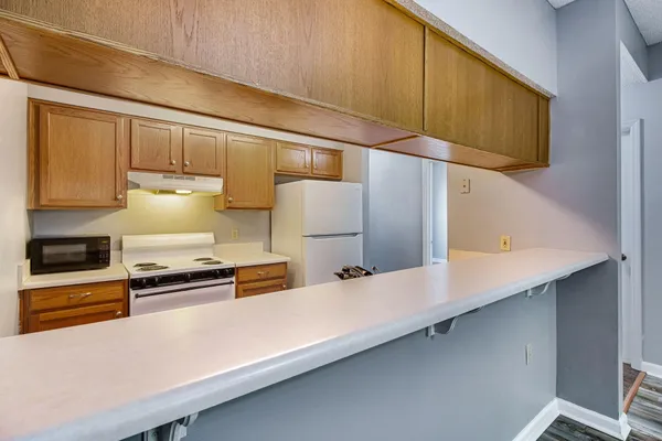 a kitchen with stainless steel appliances a cabinets and refrigerator