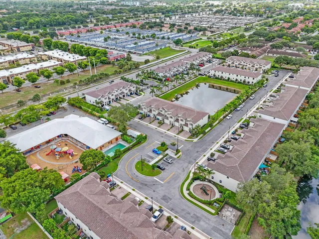 a view of multiple houses with a big yard