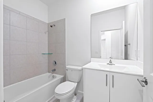 an empty room with a ceiling fan and windows