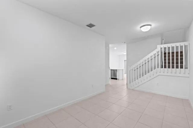 a kitchen with a refrigerator sink and stainless steel appliances
