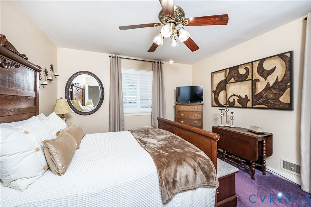 7407 Biscayne Road Henrico, VA 23294 - Photo 13 of 40 a bedroom with a bed and a flat screen tv