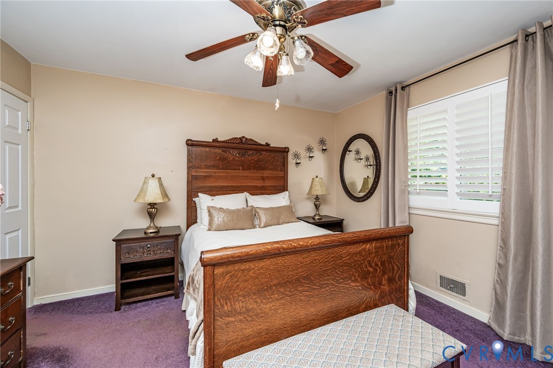 7407 Biscayne Road Henrico, VA 23294 - Photo 14 of 40 a bedroom with a bed and a chandelier
