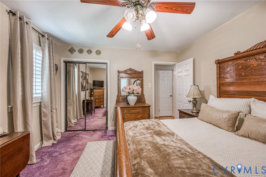 7407 Biscayne Road Henrico, VA 23294 - Photo 15 of 40 a bedroom with a bed and a chandelier