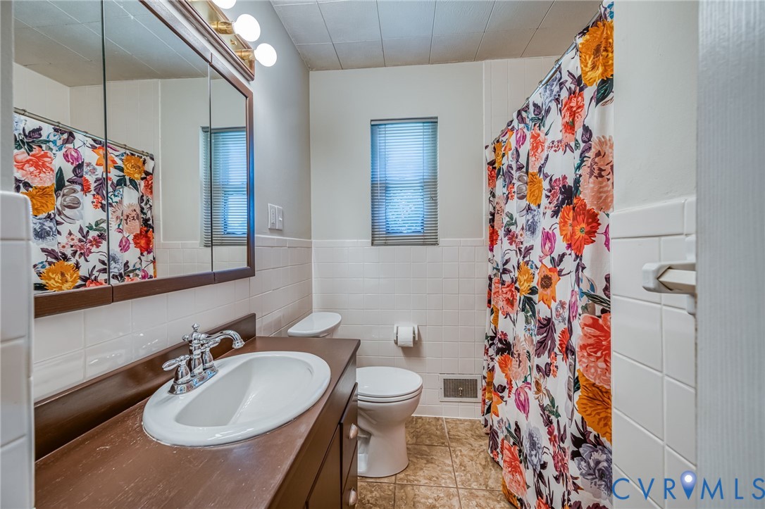 7407 Biscayne Road Henrico, VA 23294 - Photo 16 of 40 a bathroom with a sink and a mirror