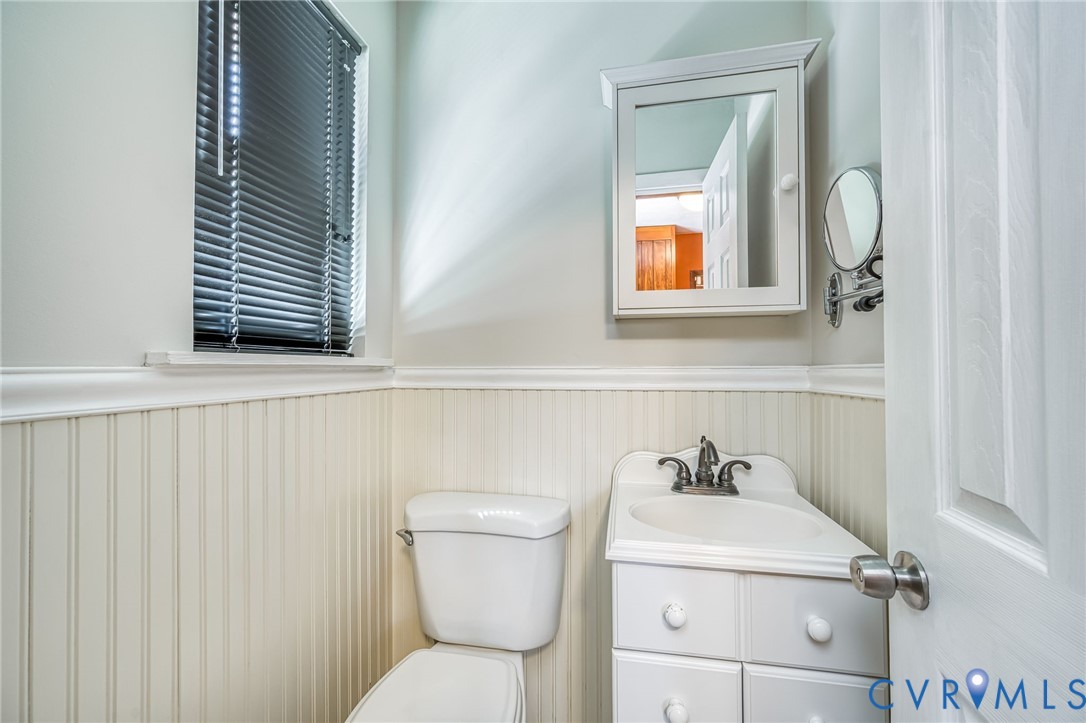 7407 Biscayne Road Henrico, VA 23294 - Photo 19 of 40 a bathroom with a toilet sink and mirror