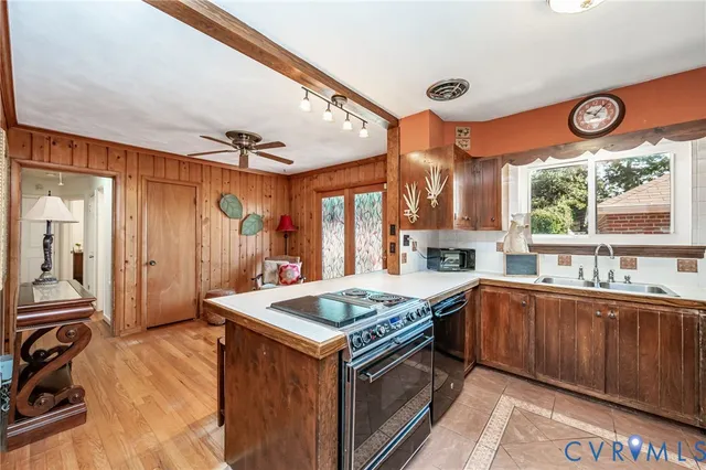 a large kitchen with a table and chairs