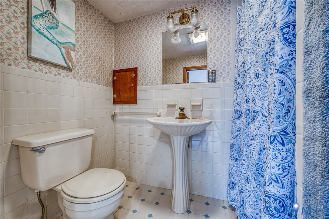 7407 Biscayne Road Henrico, VA 23294 - Photo 31 of 40 a bathroom with a sink toilet and mirror