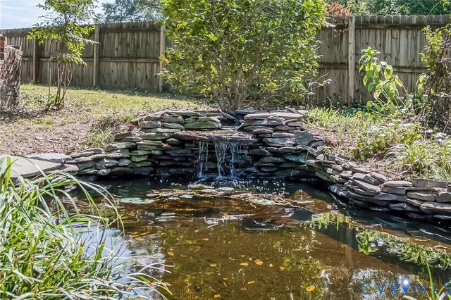 a view of a yard with plants and trees