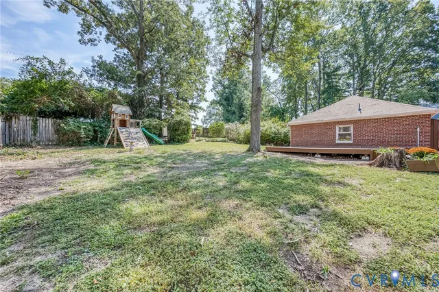 a view of a house with a yard and tree