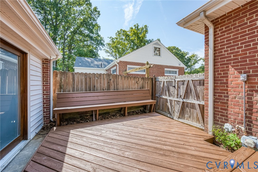 7407 Biscayne Road Henrico, VA 23294 - Photo 5 of 40 a view of a wooden deck with a bench and wooden floor