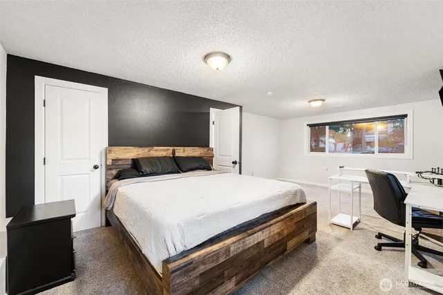 a bed room with a bed and a chair