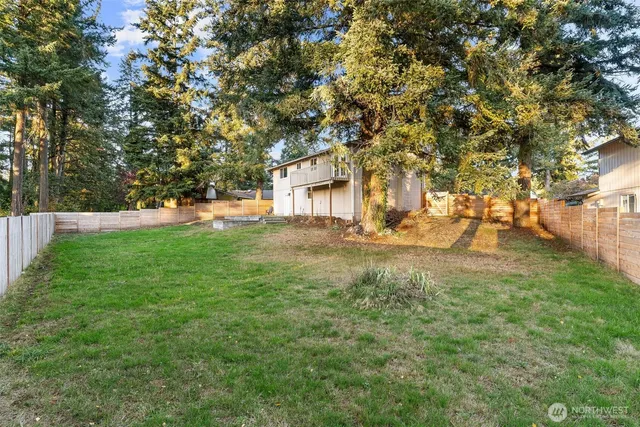 a view of house with backyard