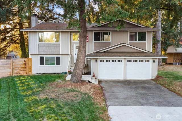 a front view of a house with a yard and garage