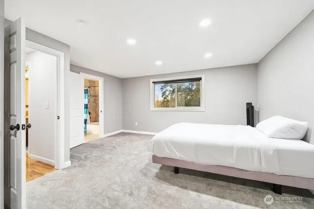 a bedroom with a large bed and a painting