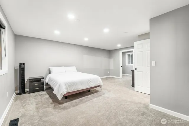 a spacious bedroom with a bed and a view of bathroom