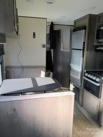 a kitchen with a sink stainless steel appliances and cabinets