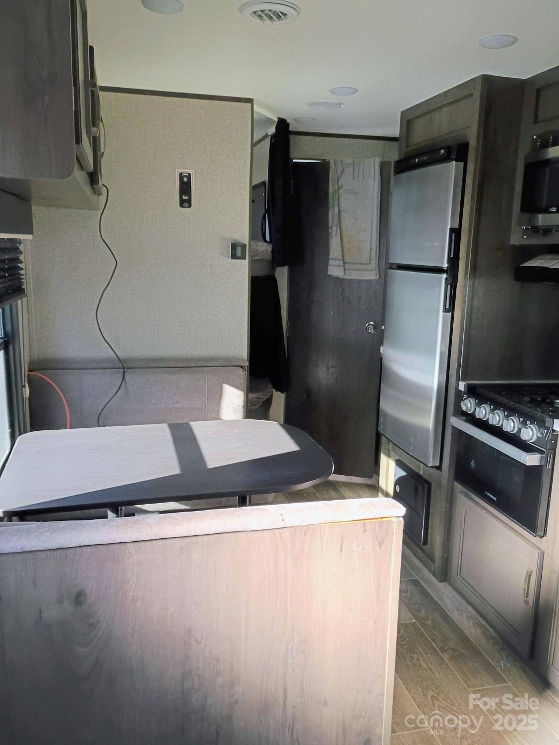 290 Wallace Road Ellenboro, NC 28040 - Photo 14 of 18 a kitchen with a sink stainless steel appliances and cabinets