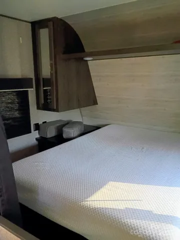 a bedroom with a bed and cabinets