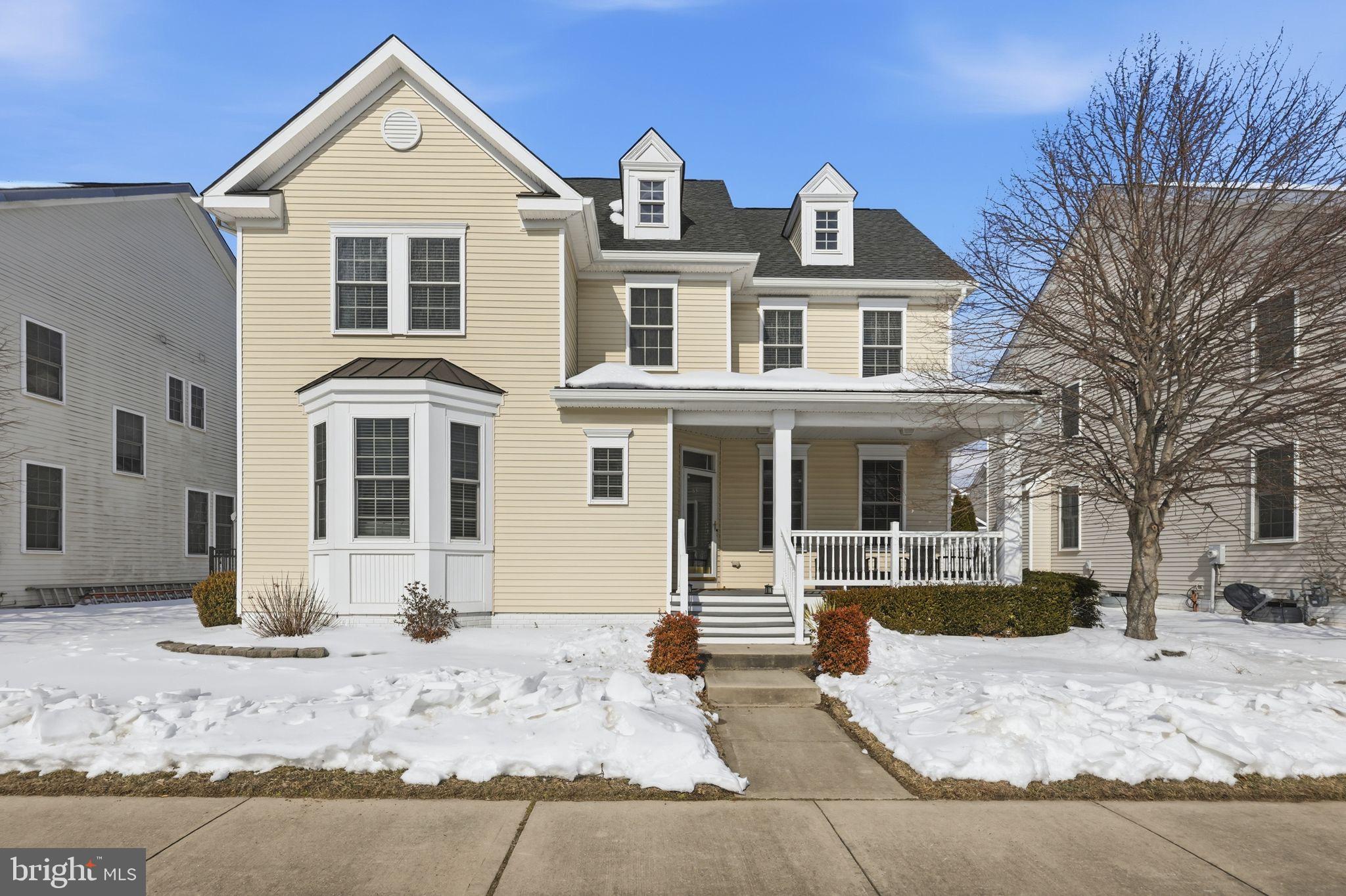 Charming home with inviting porch and snow.