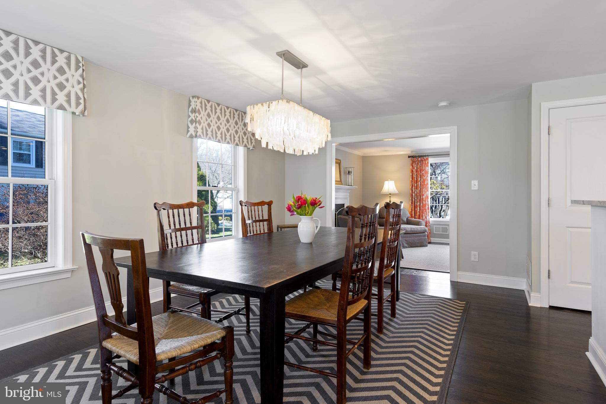 129 Clover Hill Lane Wayne, PA 19087 - Photo 16 of 41 a view of a dining room and livingroom with furniture wooden floor a chandelier
