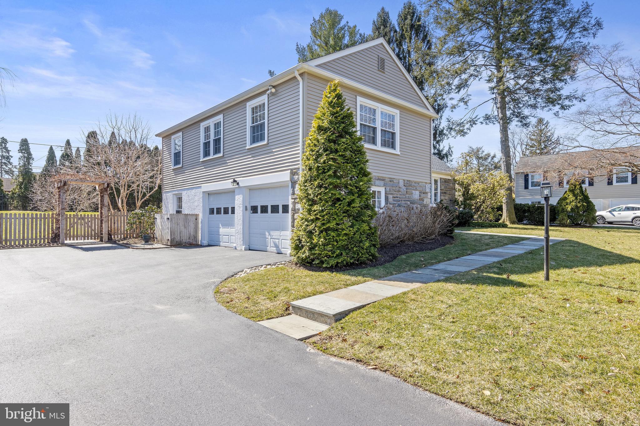129 Clover Hill Lane Wayne, PA 19087 - Photo 3 of 41 a front view of a house with a yard